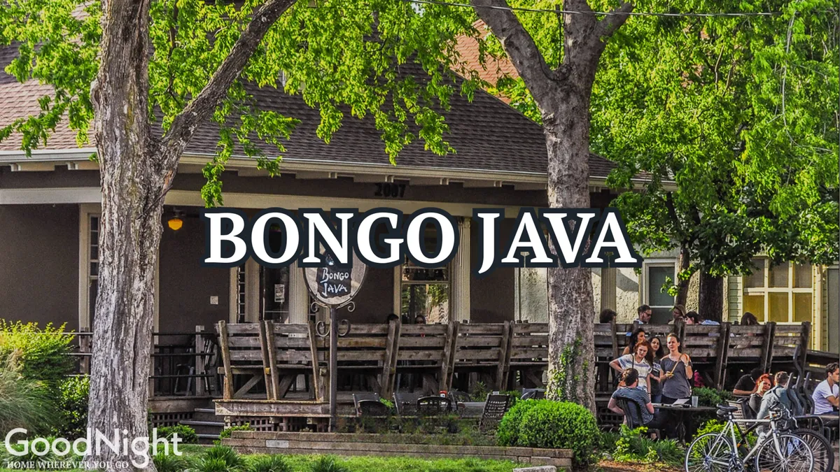 An inviting coffee shop exterior with the 'Bongo Java' sign, outdoor seating, and people socializing beneath leafy trees. The atmosphere is relaxed and welcoming, encouraging visitors to enjoy a coffee, connect with friends, or simply unwind in the neighborhood.